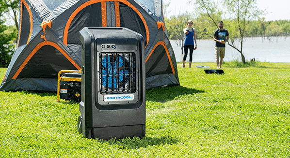 Small Portacool next to a camping tent in the wilderness with a small portable generator in the background.