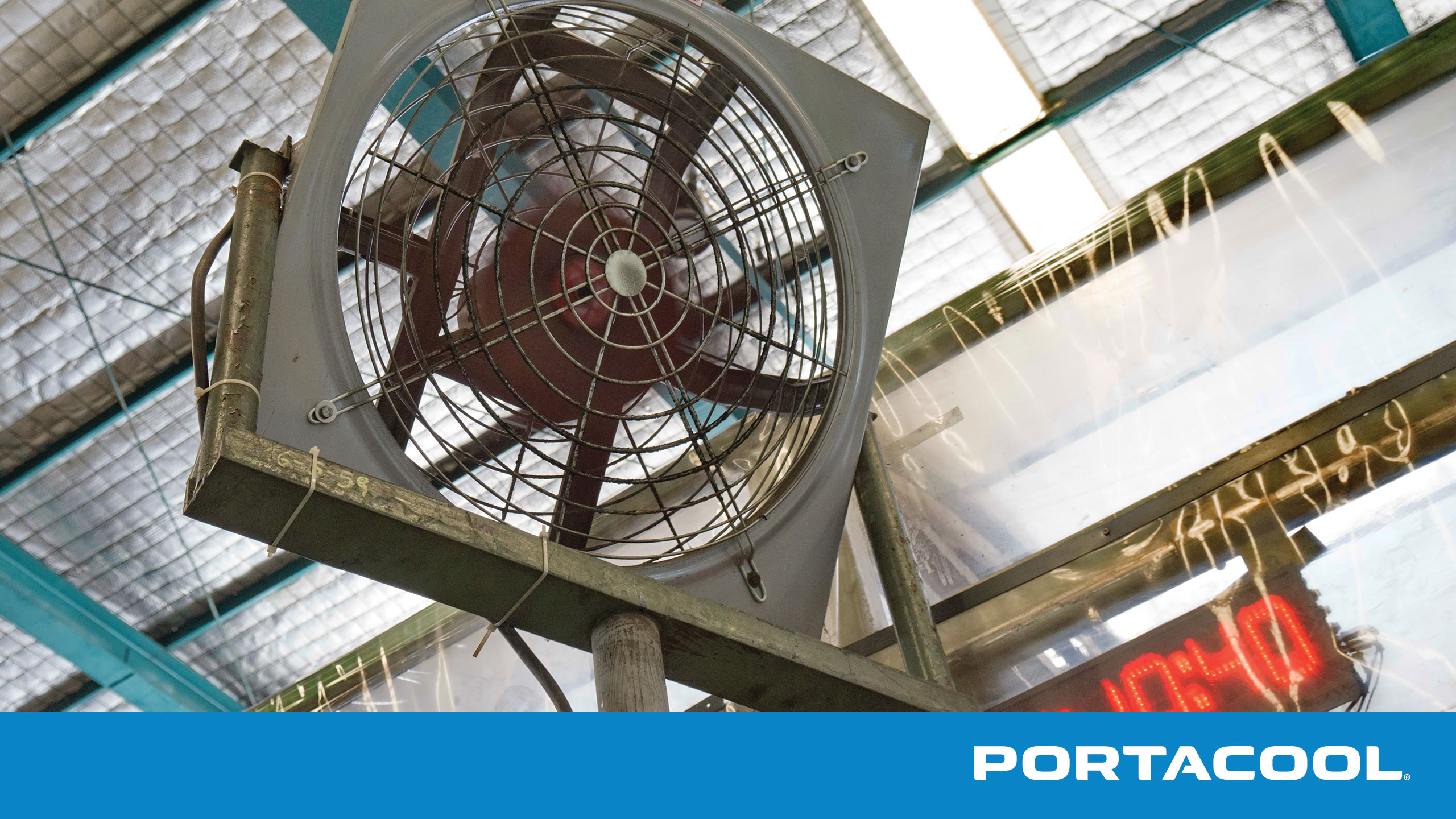 An industrial fan strains as it tries to cool down an industrial space.