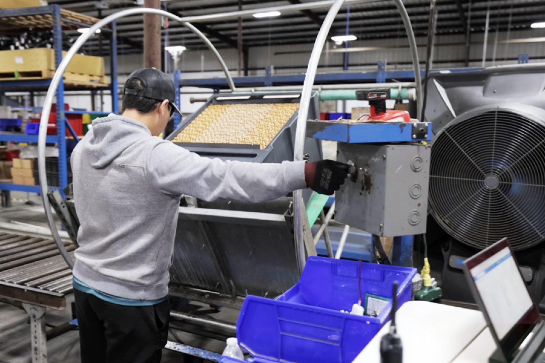 A worker in a grey hoodie and black cap builds a Portacool Evaporative Cooler in their US Based factory.