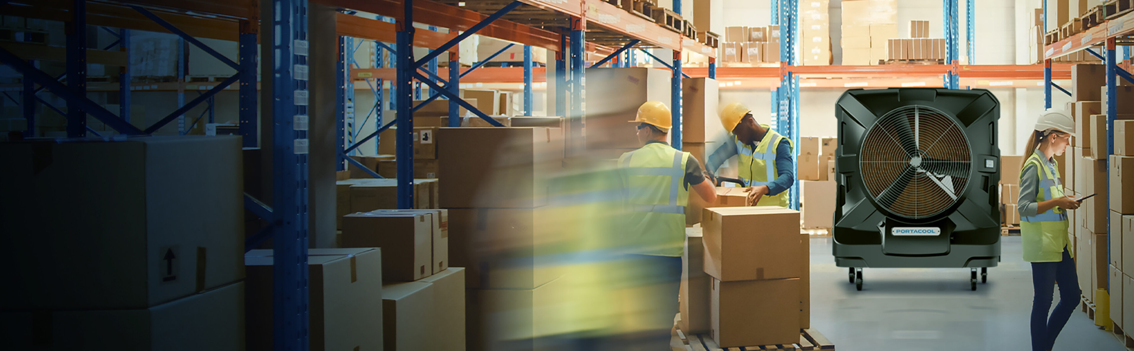 Workers in an industrial warehouse are comfortable and happy because of the effective cooling by the large evaporative cooler behind them.