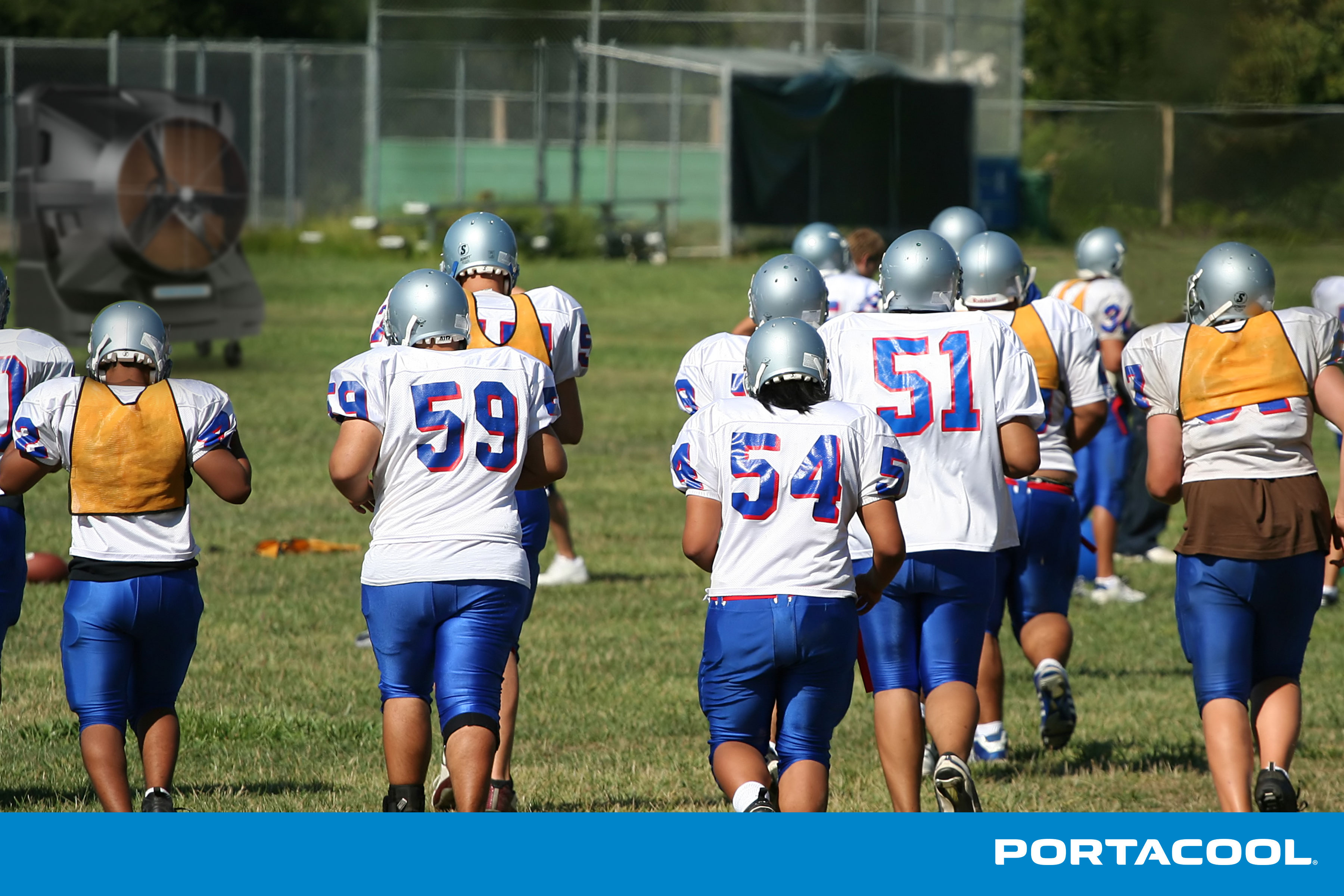 A football trains in the heat, but is kept safe and cool by a Portacool evaporative cooler.