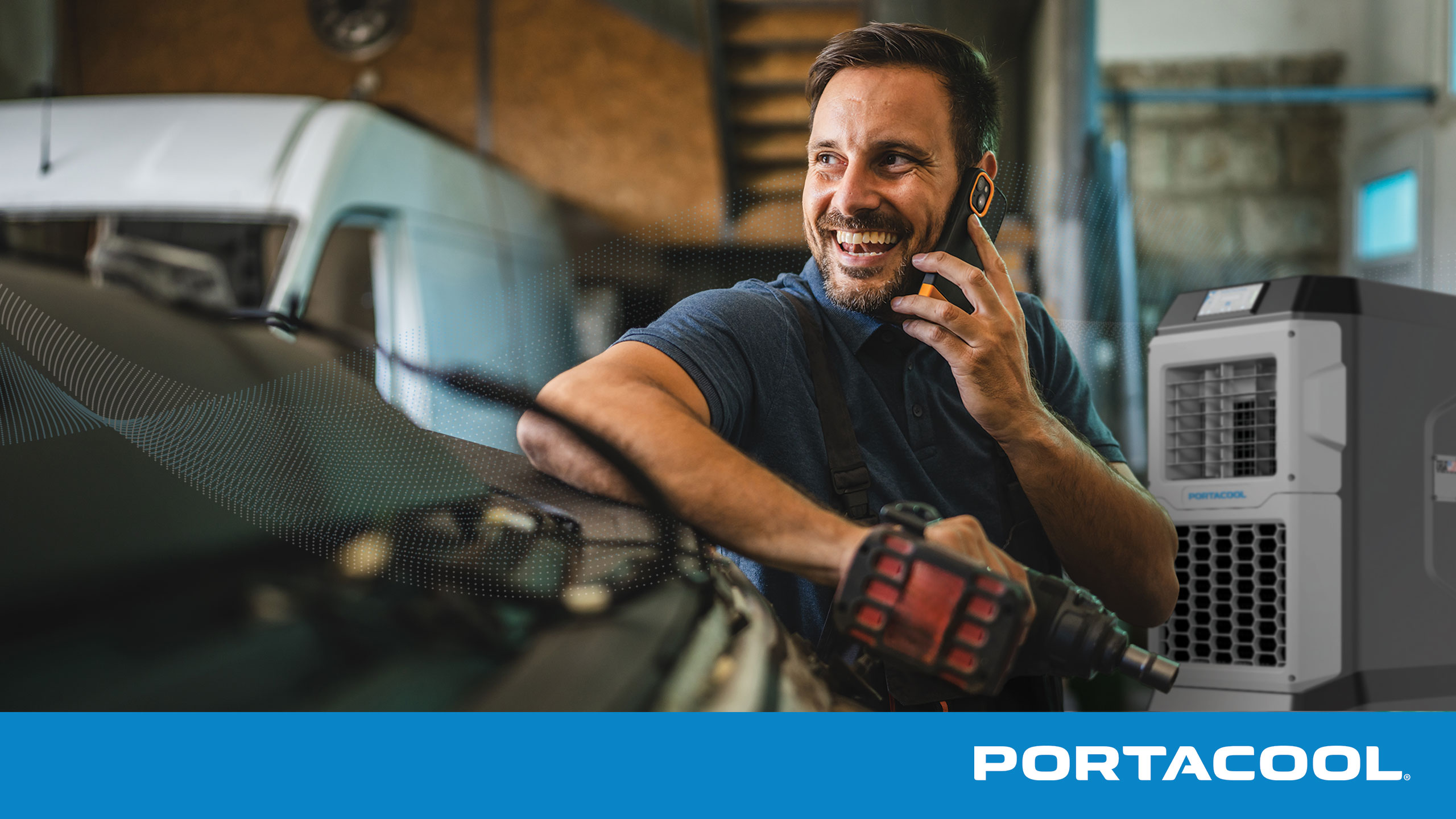 A car mechanic talks on the phone in an automotive service shop, with a Portacool evaporative cooler running in the background.