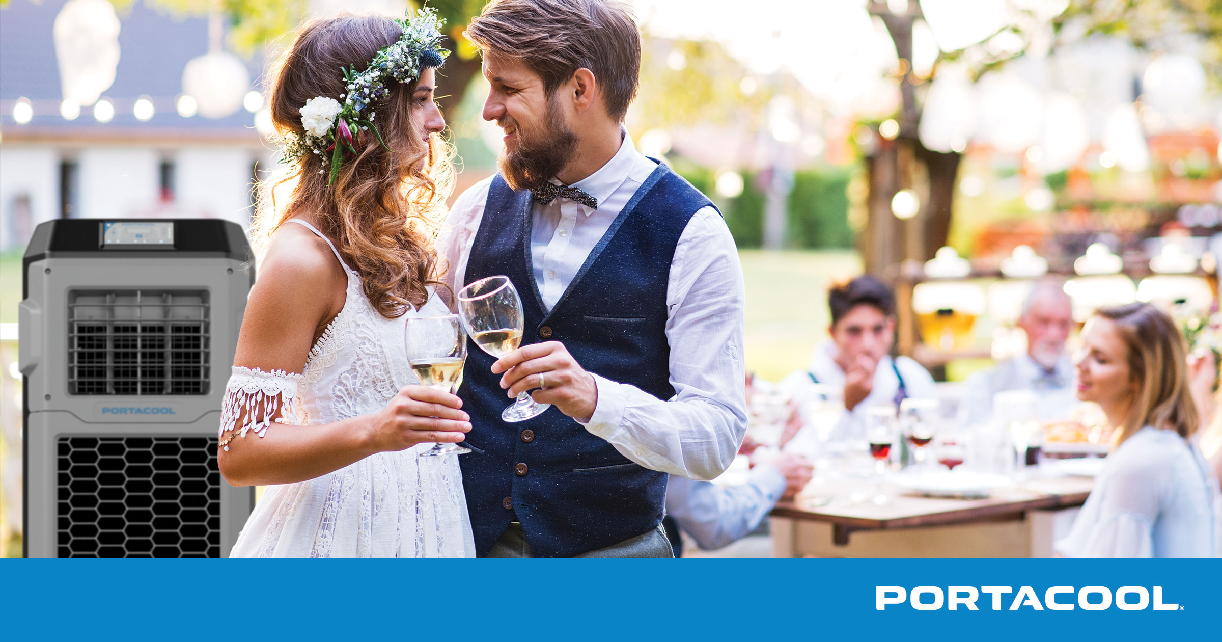 a bride and groom holding wine glasses at a wedding with a Portacool evaporative cooler in the background