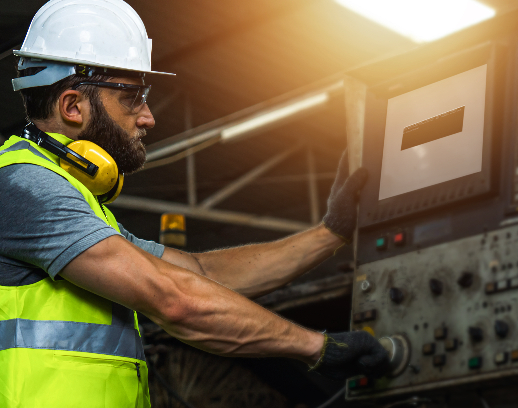 An industrial worker interfacing with industrial equipment, being kept cool by a Portacool APEX 700 evaporative cooler equipped with a VORTEX precision cooling kit.